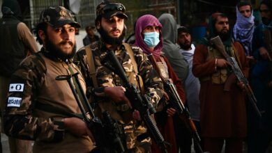 Taliban fighters stand guard near the military hospital in Kabul, Afghanistan