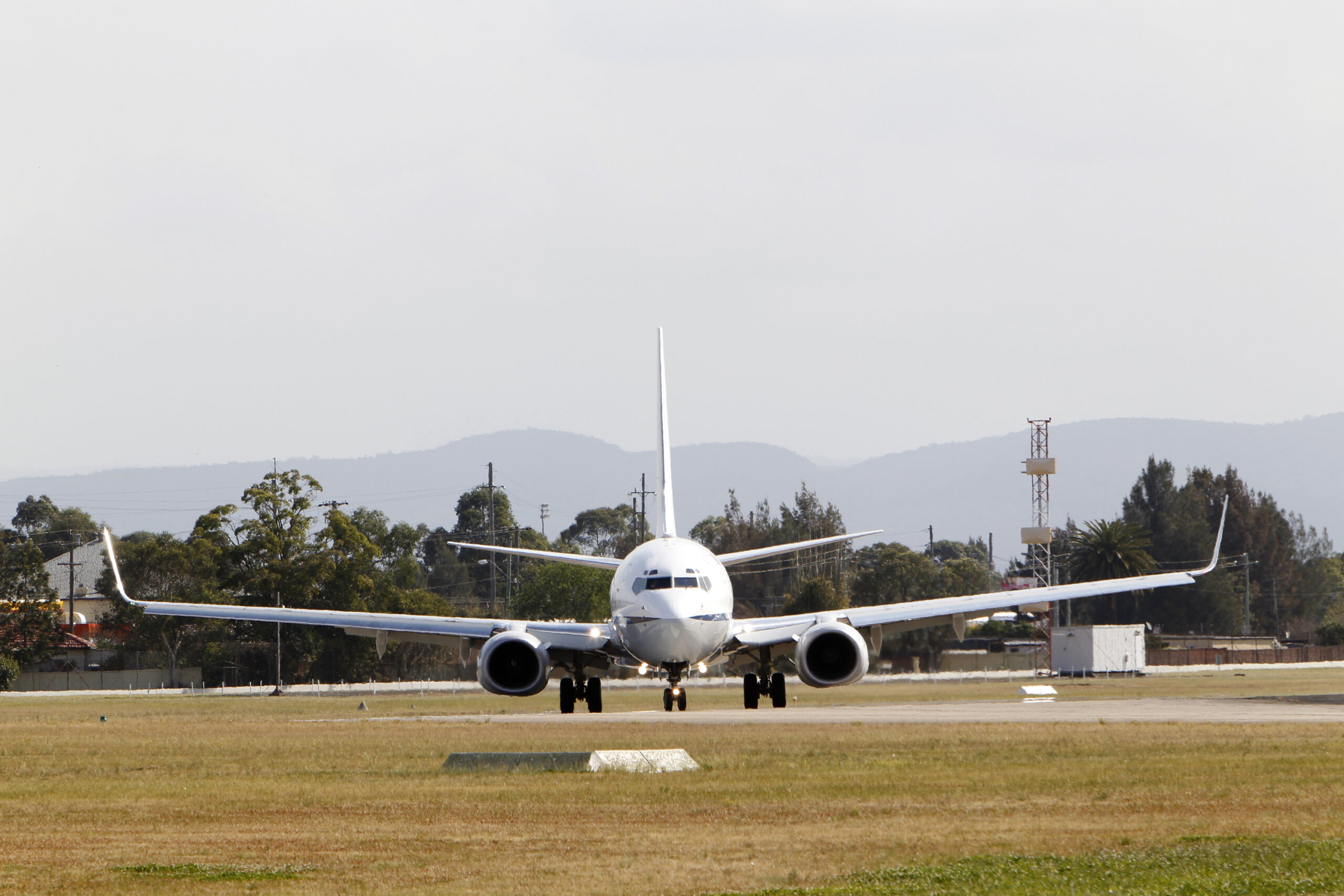 No. 34 Squadron (34SQN) Boeing Business Jet (BBJ) A36-001 taxis off the runway at RAAF Base Richmond. Mid-caption: No. 34 Squadron Royal Australian Air Force (RAAF) has operated a pair of Boeing Business Jets (BBJs) since 2002, with the aircraft routinely utilised by the Australian Government for long distance and international tasking. The range and passenger capacity of the BBJ allows the Australian Government to reach its people across the vast distances of this country, as well as ensuring Australia maintains its place on the world stage during international events, meetings and conferences.