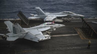 An F/A-18F Super Hornet and an EA-18G Growler prepare to launch