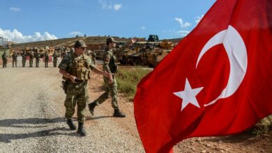 Turkish soldiers with the Turkish flag flying