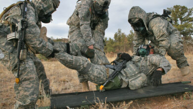 Soldiers with 1st Squadron, 10th Cavalry Regiment, 2nd Brigade Combat Team, 4th Infantry Division, move an injured soldier onto a litter during the chemical, biological, radiological and nuclear testing phase during the squadron's annual spur ride, Nov. 1, 2012. The tasks the spur candidates were required to complete included a physical fitness test, a written test, vehicle identification, an obstacle course and a land navigation course carrying a 40-65 pound rucksack and at each point on the course they were tested on basic soldiering skills. (U.S. Army photo by Staff Sgt. Ruth Pagan, 2nd BCT PAO, 4th Inf. Div.)