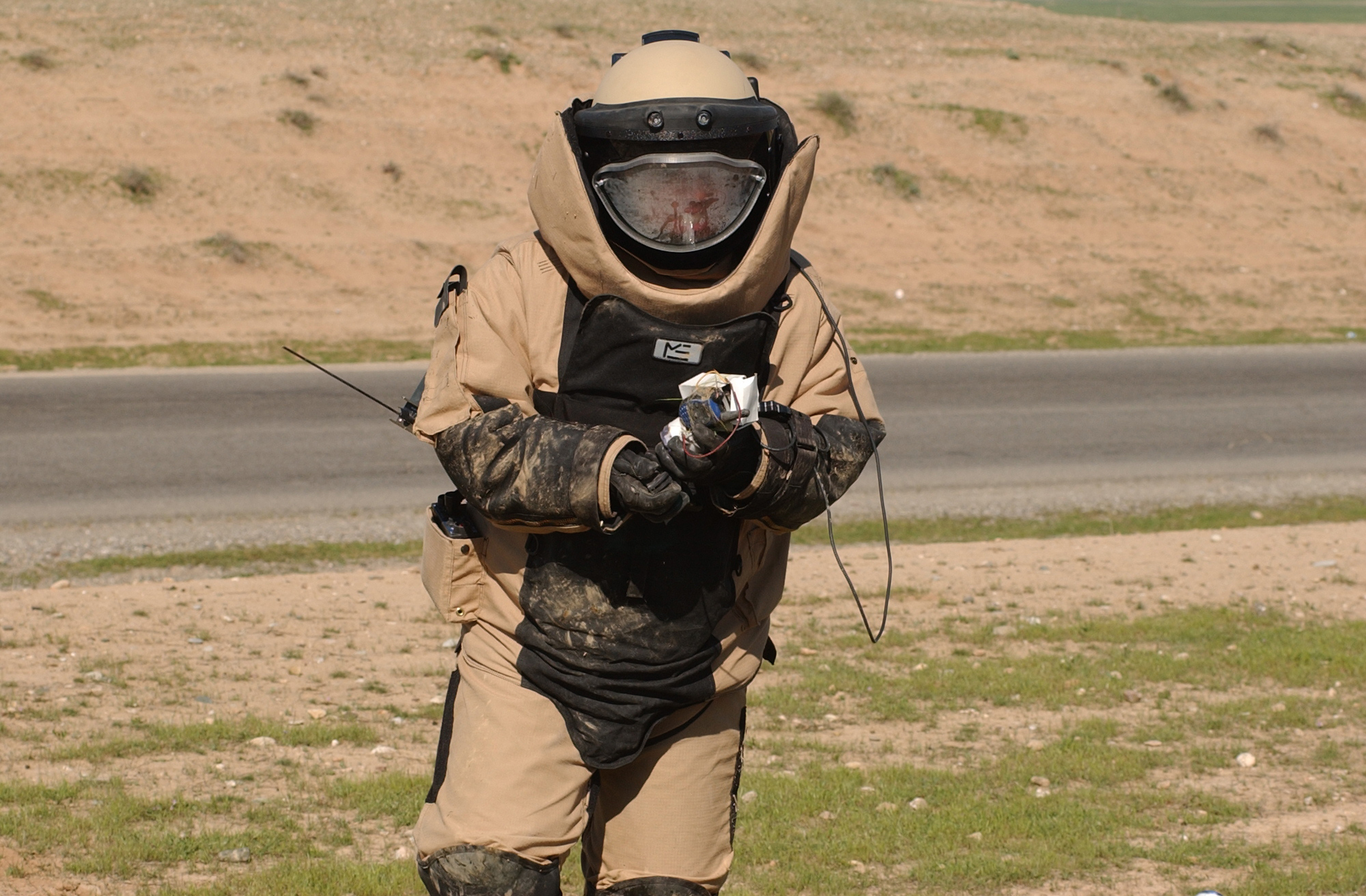 Air Force Staff Sgt. Nate Wills, EOD team sergeant, 506th Expeditionary Civil Engineer Squadron, recovers a Motorola radio after disarming an improvised explosive device. Insurgents use the radios are used to detonate the IED's when American forces are in the blast radius.