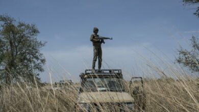 A guard on top of a vehicle in Benin