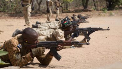 Burkinabe soldiers fire their rifles during a marksmanship training