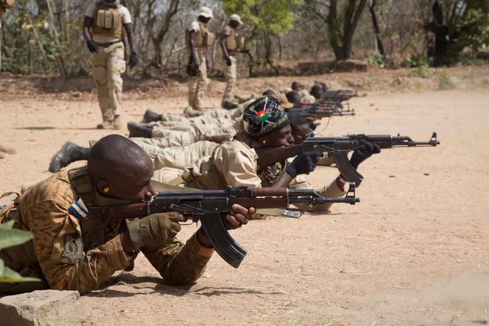 Burkinabe soldiers fire their rifles during a marksmanship training