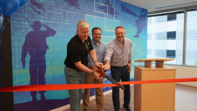 Andy Green, executive vice president of HII and president of HII's Mission Technologies division, Steve Wagner, vice president of operations at HII’s Enlighten subsidiary, and Grant Hagen, president of the Cyber, Electronic Warfare, and Space business group in HII's Mission Technologies division, celebrate the opening of Enlighten’s new office facility in Columbia, Maryland.