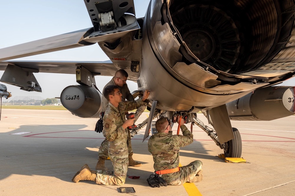 Crew chiefs assigned to the 114th Aircraft Maintenance Squadron prepare to take off a ventral fin in a F-16