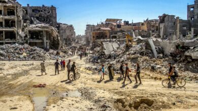 Palestinians walk among the rubble after returning to their neighborhood destroyed during the Israeli military operations lasting for 3 weeks in Jabalia, Gaza