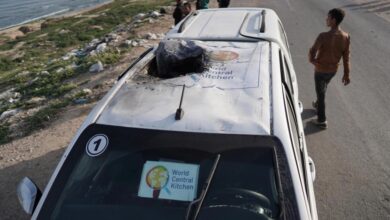 The roof of a charred vehicle with the group's logo shredded by the impact of the strike.