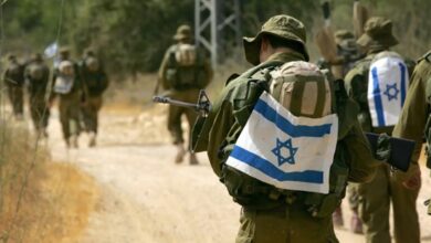 Israeli army paratroopers march through the Israeli countryside