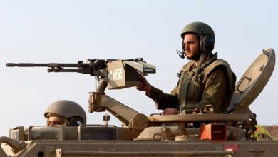 Israeli soldiers move in a convoy at an undisclosed location bordering the Gaza Strip