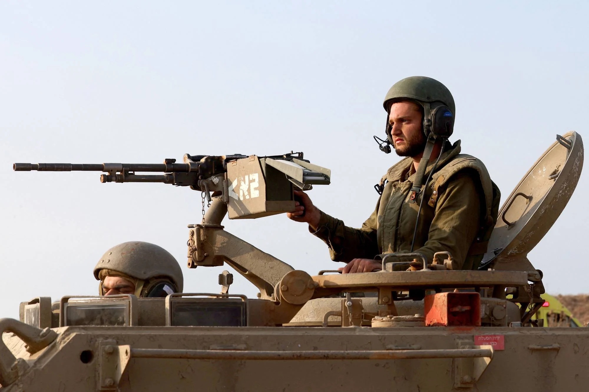 Israeli soldiers move in a convoy at an undisclosed location bordering the Gaza Strip