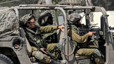 Israeli army soldiers sit in a humvee at a checkpoint near the border with the Gaza Strip, Sderot, Israel