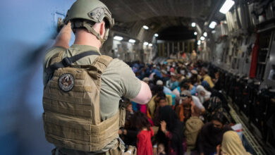 A US Air Force security forces raven maintains security aboard a US Air Force C-17 Globemaster III aircraft in support of the Afghanistan evacuation at Hamid Karzai International Airport