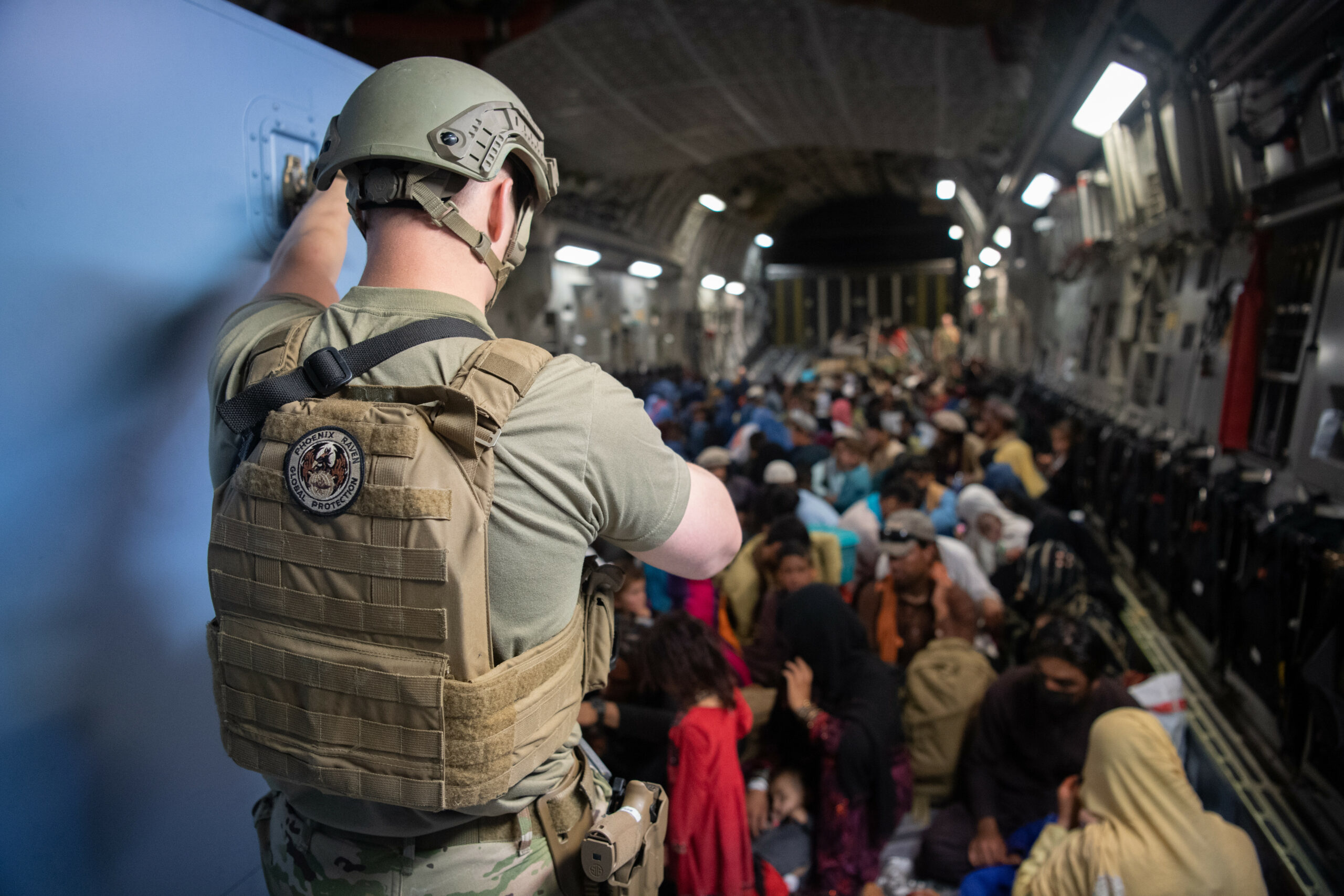 A US Air Force security forces raven maintains security aboard a US Air Force C-17 Globemaster III aircraft in support of the Afghanistan evacuation at Hamid Karzai International Airport