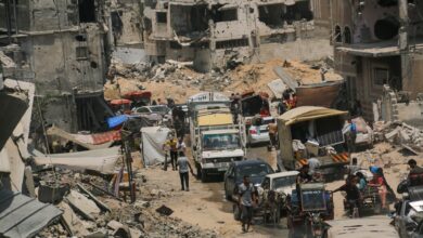 Displaced Palestinians flee their homes with their belongings in the city of Khan Yunis, in the southern Gaza Strip, July 2024