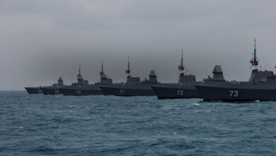 Six Formidable-class Frigates are seen lined up in ocean waters. The grey-colored ships have their numbers painted on their hull, from 68 to 72.