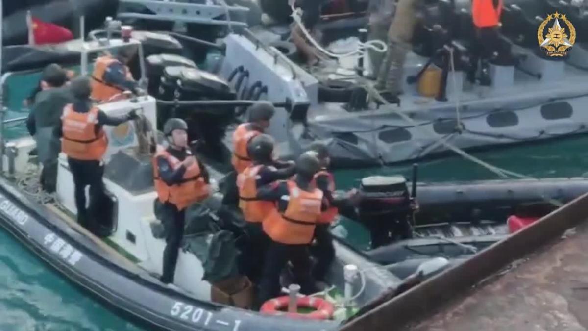 Chinese sailors wield knives and an axe in a clash with Philippine naval vessels near a strategic reef in the South China Sea