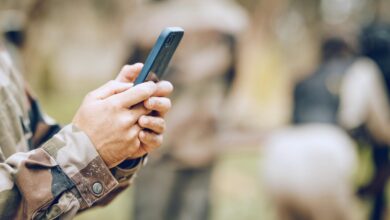 Soldier holding phone in his hand