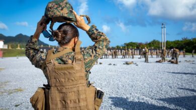 US Marine Corps Sergeant places on a kevlar.