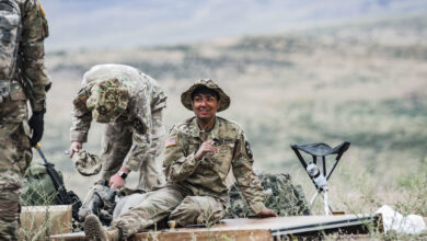 Specialist prepares a door for a breaching exercise on a demolitions range at the Yakima Training Center