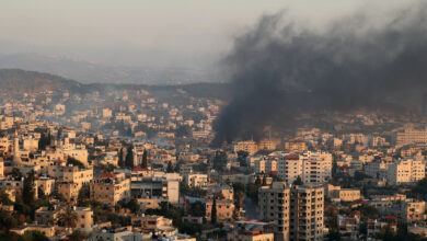 Smoke billows from houses inside the Jenin refugee camp in the northern West Bank city of Jenin