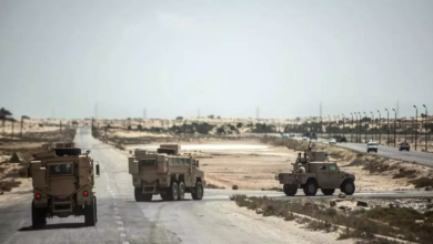 Egyptian officers drive on a route leading to El-Arish, the capital of North Sinai province, Egypt, on July 26, 2018.