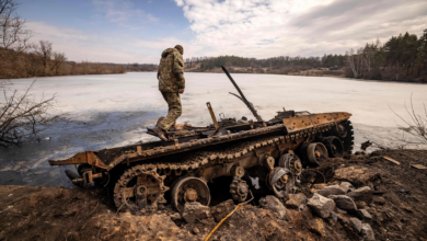 Ukrainian servicemember on destroyed Russian tank